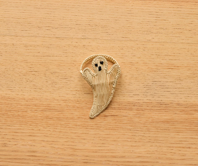 Handmade rattan ghost napkin ring on neutral background – Halloween-themed rustic boho table decor accessory