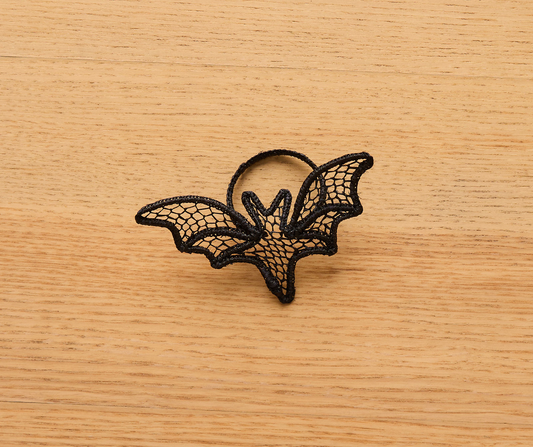 Handmade Halloween napkin ring shaped like a black lace bat. Lightweight and perfect for spooky, gothic, or witchy fall table settings.