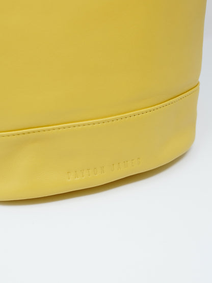 Italian Leather Tote handbag close up of name brand on bag wood bucket tote lemon yellow color by payton james