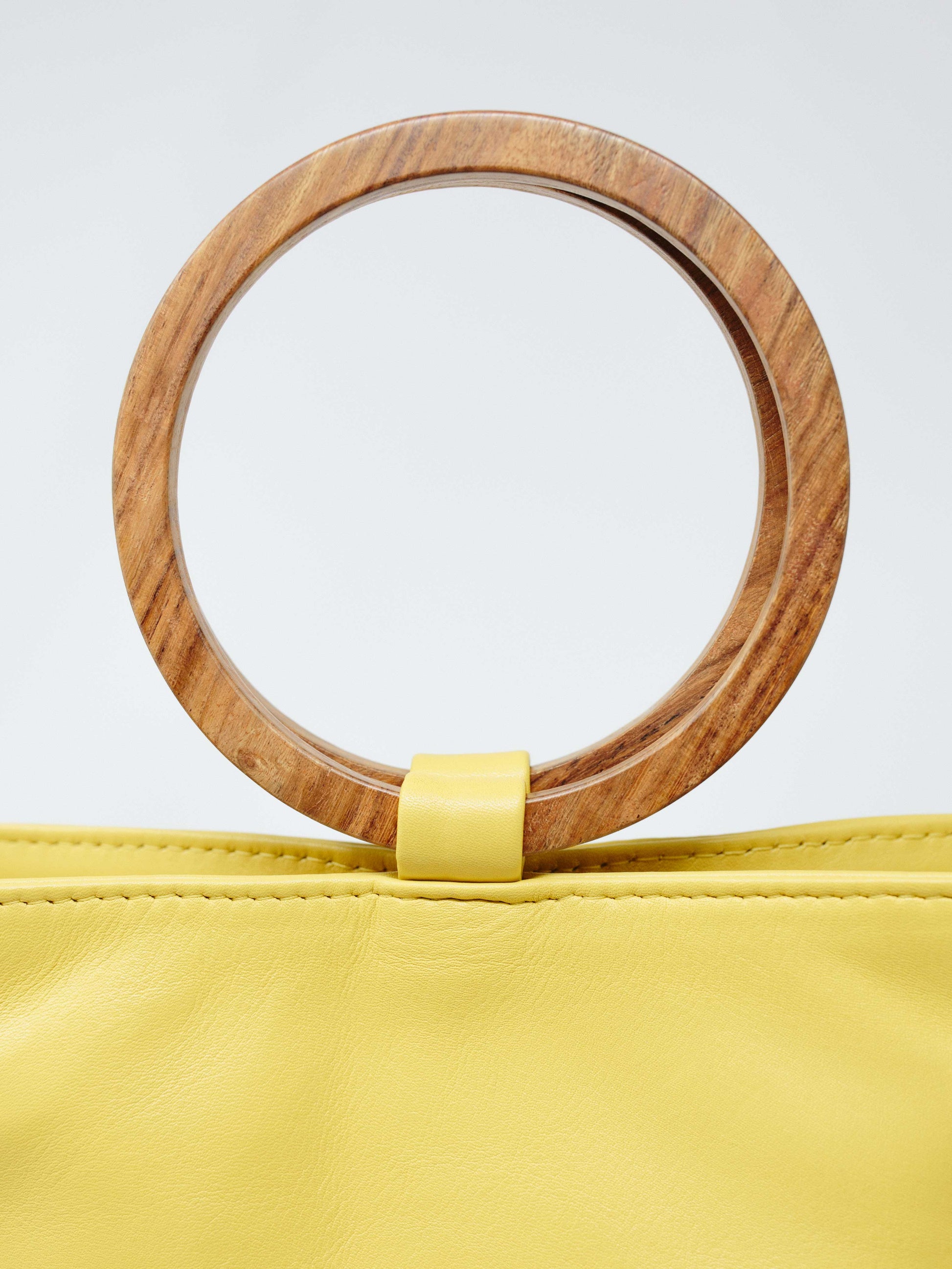 Leather Tote handbag- closeup of wood handle on wood bucket tote lemon yellow color by payton james