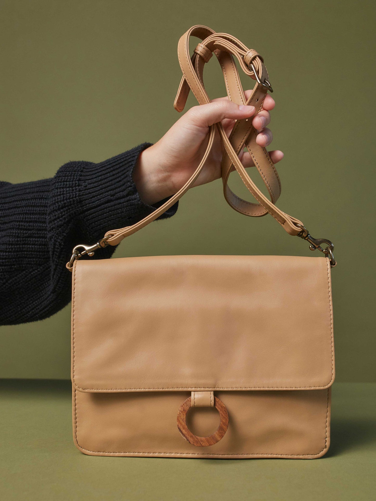 Model holding strap of Leather-wallet crossbody bag - Wood Wallet Crossbody cappuccino color handbags by payton james Nashville leather handbag designer